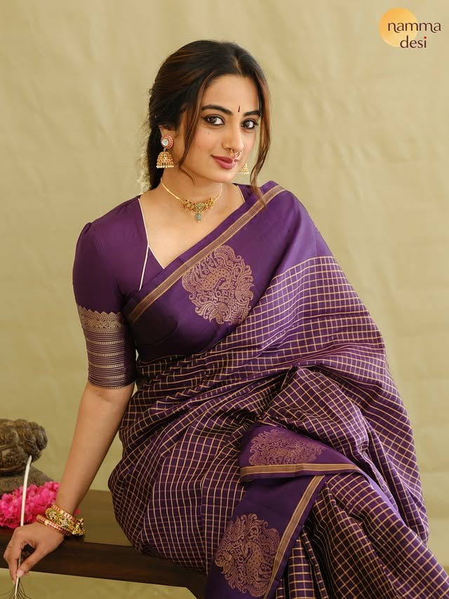 If you get into Vasanthamallika zone you can’t get out of it ! 🫶🏽
Royal Purple Kanchipuram Saree from @namma.desi ♥️
Adorned with classic kattam zari designs all over the body, this elegant Kanchipuram saree features a gap border highlighted with large deer motifs in between. The richly woven pallu and matching blouse with zari-detailed sleeves complete its timeless charm.
Price -20,950 /- 
Makeup @abilashchickumakeupartist 
Jwellery- @anni_jewellery
